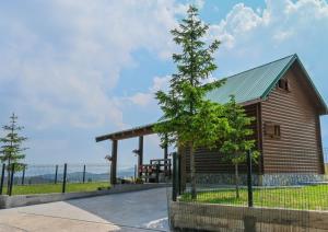 a small wooden building with a tree in front of it at Mountain Viewpoint in Žabljak