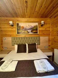 a bedroom with a bed with two towels on it at Ensar Apart in Uzungöl