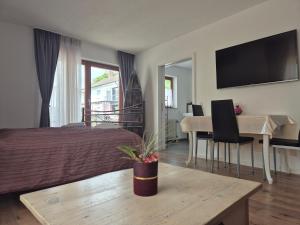 a bedroom with a bed and a table and a desk at Apartment Rosalie Burgblick EuropaPark in ca 15min erreichbar in Kenzingen