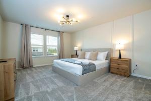a bedroom with a bed and a large window at Modern and Spacious 5BR Villa Near Disney with Private Pool and Themed Bedrooms in Orlando