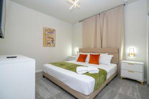 a bedroom with a bed with orange and white pillows at Modern and Spacious 5BR Villa Near Disney with Private Pool and Themed Bedrooms in Orlando