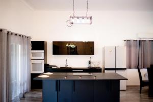a kitchen with a large island in the middle at Oléa villa & lodge in Marrakesh