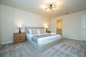 a bedroom with a bed and a ceiling fan at Modern and Spacious 5BR Villa Near Disney with Private Pool and Themed Bedrooms in Orlando +130 photos