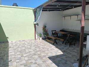 a patio with a table and chairs in a room at Cozy accommodation 3 min Distrito Uno in Chihuahua