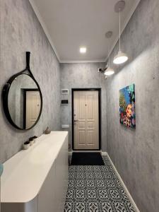 a bathroom with a sink and a mirror on the wall at Altin Residens in Karagandy