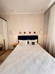 a bedroom with a large white bed with white pillows at Altin Residens in Karagandy