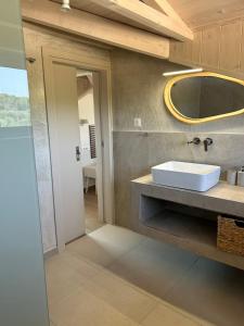 a bathroom with a sink and a mirror on the wall at Alestone Villa by the sea in Vasilikos