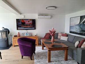 a living room with a couch and a table at Villa Lakeside in Osbyholm