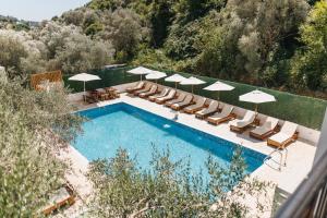 an overhead view of a swimming pool with chairs and umbrellas at Eman Resort in Ulcinj