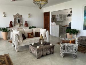 a living room with a white couch and a table at Luxury Penthouse 7 Islands View at Ocean Pearls in Watamu