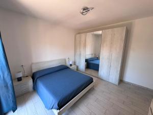 a bedroom with a blue bed and a mirror at Al' Rrigo in Bolsena
