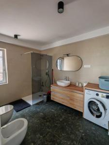 a bathroom with a washing machine and a washer at Apartment La Lita in Šmarje +22 photos