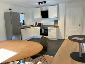 a kitchen with a table and two chairs and a table at Ferienwohnung Gräfendhron in Gräfendhron +35 photos