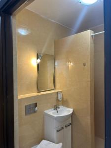 a bathroom with a sink and a mirror at Willa Kalinowa in Sopot +26 photos