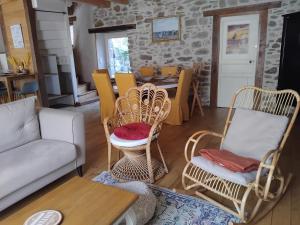 a living room with a couch and chairs and a table at Spacious 3 bedroom house 250m from Saint-Suliac's beach in Saint-Suliac