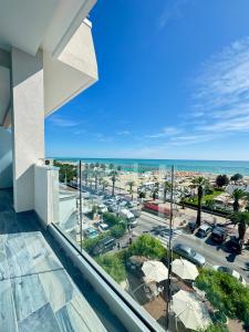 a balcony with a view of a city and the ocean at Hotel Continental in Tortoreto Lido