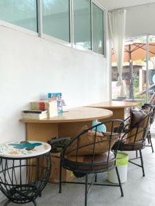 a room with two chairs and a table and a table at Irene Hotel in Chiang Mai