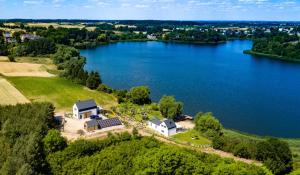 an aerial view of a house on the shore of a lake at Dom nad Jeziorem in Ostrowite