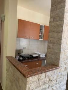 a kitchen with a stone counter top in a room at Čanj apartmani in Čanj +21 photos