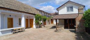 a row of houses with a brick courtyard at Petrovaradinski Dvor in Petrovaradin