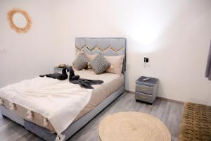 a bedroom with a bed with a mirror and a table at Oléa villa & lodge in Marrakesh
