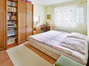 a bedroom with a bed with a dresser and a window at Vila Magnolia in Bijela