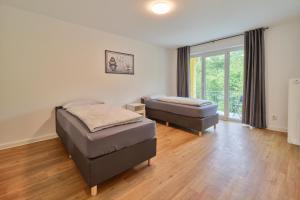 เตียงในห้องที่ Monteurwohnungen - Romika Apartments - Nähe Trier - großer Parkplatz