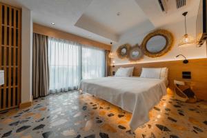 a bedroom with a large bed and a mirror at Casa Colore Boutique House in Bodrum City