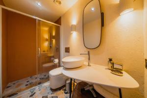 a bathroom with a sink and a toilet and a mirror at Casa Colore Boutique House in Bodrum City +159 photos