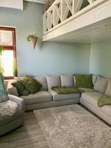 a living room with a gray couch in a room at Apartment for 5 people in Savonlinna