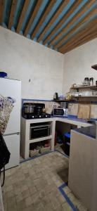 a kitchen with a stove and a counter top at Riad chrifa in Tangier +12 photos