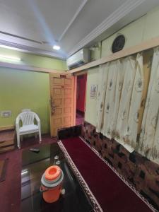 a room with a bench and a window with curtains at hotel aadarsh in Sendhwa