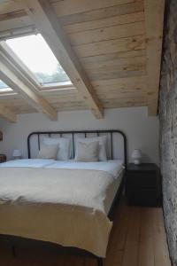 a bedroom with a large bed with a skylight at Viktor Estate in Deskle +14 photos