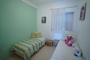 Ένα ή περισσότερα κρεβάτια σε δωμάτιο στο Apartment in Ryad Sofia Martil 2 bedrooms all comforts