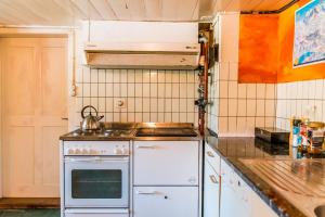 a kitchen with a stove and a tea kettle on it at Simple and Rustic - Apartment in Historic House in Wilderswil