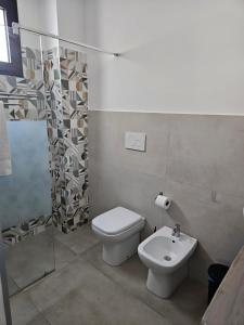 a bathroom with a toilet and a sink at B&b Anna Leverano in Leverano
