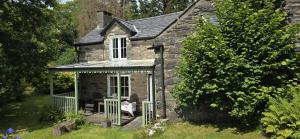 an old stone cottage with a gazebo at Nature cottage in Snowdonia National Park in Beddgelert +3 photos