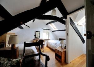 a bedroom with a bed and a room with a ceiling at Nature cottage in Snowdonia National Park in Beddgelert