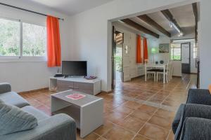 een woonkamer met twee banken en een tv bij La Rafal in Pollença