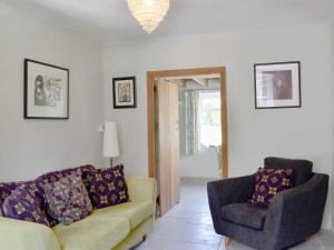 a living room with a couch and a chair at The Mill Farmhouse in Llandybie