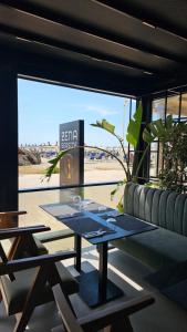 a table in a room with a view of the beach at Zena Hotel Durres in Durrës
