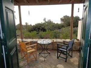 a patio with a table and chairs on it at Marathos in Kanakis
