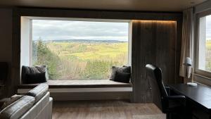 a room with a window seat with a view at Villa des Grues à Filly in Houffalize