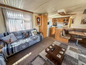 a living room with a couch and a kitchen at Superb 8 Berth Caravan At Southview Holiday Park Ref 33164Ml in Skegness