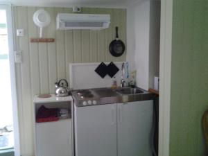 a small kitchen with a sink and a refrigerator at Lunheim in Geiranger in Geiranger