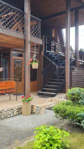 a porch of a house with a spiral staircase at Relax in Melʼniki