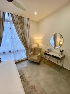 a bedroom with a bed and a desk and a mirror at Sky Park Tower Premium Apartments Gulberg Greens Islamabad in Islamabad