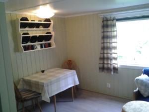 a dining room with a table and a window at Lunheim in Geiranger in Geiranger