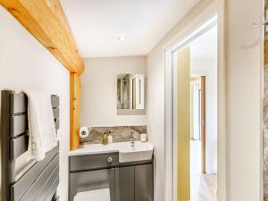 a bathroom with a sink and a mirror at Rhosyn - Uk40260 in Llangadfan +9 photos