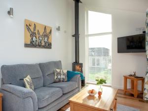 a living room with a couch and a table at Wonkey Donkey Cottage in Seaton